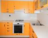 угловая кухня с матовыми фасадами из пластика оранжевого цвета и светлой столешницей на заказ 1