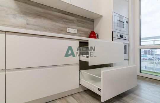 Угловая светлая кухня с матовыми фасадами из МДФ, без ручек 