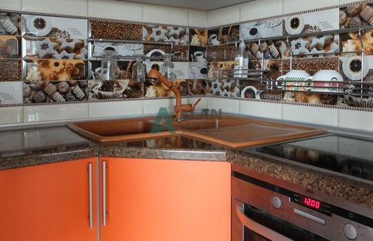 большая Г-образная кухня оранжевого цвета с темной столешницей под заказ по индивидуальным размерам 